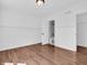 Clean bedroom with hardwood floors, paneled walls, neutral paint, and a walkthrough to the bathroom at 10792 Harbor Bay Dr, Fishers, IN 46040