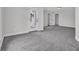 A carpeted bedroom with neutral colors, a glass panel door, and natural light at 10792 Harbor Bay Dr, Fishers, IN 46040