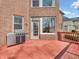 Outdoor deck featuring red wood and stainless steel grill with a view of the brick home at 10792 Harbor Bay Dr, Fishers, IN 46040