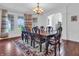 Formal dining room with decorative rug, chandelier, and large windows providing abundant natural light at 10792 Harbor Bay Dr, Fishers, IN 46040