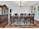 Elegant dining room with a large table, chairs, an ornate cabinet, and a decorative chandelier at 10792 Harbor Bay Dr, Fishers, IN 46040