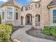An arched entryway welcomes visitors with beautiful stone facade, providing classic charm at 10792 Harbor Bay Dr, Fishers, IN 46040