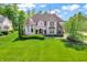A beautiful home with a lush green lawn, a turret and a mix of brick and stone accents at 10792 Harbor Bay Dr, Fishers, IN 46040