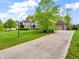 Elegant home with lush lawn, mature trees, and a lamp post enhancing its curb appeal at 10792 Harbor Bay Dr, Fishers, IN 46040