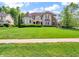 This home boasts a turret, balcony and a blend of brick and stone accents, complemented by a green lawn at 10792 Harbor Bay Dr, Fishers, IN 46040