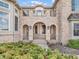 The arched entryway features stone columns and a balcony, enhancing the home's sophisticated appeal at 10792 Harbor Bay Dr, Fishers, IN 46040