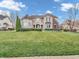 The front exterior of this two-story home is clad in stone and brick with a manicured lawn at 10792 Harbor Bay Dr, Fishers, IN 46040