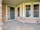 The front porch features a secure entrance and is flanked by large windows and stylish stone accents at 10792 Harbor Bay Dr, Fishers, IN 46040