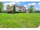 Stately home featuring a well-manicured lawn, mature trees, and elegant architectural details at 10792 Harbor Bay Dr, Fishers, IN 46040