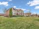 Elegant home showcasing a large front yard with lush grass and refined landscaping at 10792 Harbor Bay Dr, Fishers, IN 46040
