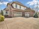 Three-car garage with brick and stone accents, and a wide driveway provides ample parking space at 10792 Harbor Bay Dr, Fishers, IN 46040