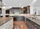 Modern kitchen featuring dark cabinets, granite countertops, and stainless steel appliances at 10792 Harbor Bay Dr, Fishers, IN 46040