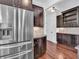 This gourmet kitchen features stainless steel appliances, tile backsplash, and dark wood cabinetry at 10792 Harbor Bay Dr, Fishers, IN 46040