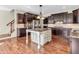 Spacious kitchen featuring dark wood cabinets, a center island and modern stainless steel appliances at 10792 Harbor Bay Dr, Fishers, IN 46040