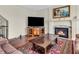Living room showcasing a fireplace, hardwood floors, television, and a decorative rug at 10792 Harbor Bay Dr, Fishers, IN 46040