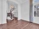 Spacious room with hardwood flooring, staircase access, large windows, and elegant white trim and decor at 10792 Harbor Bay Dr, Fishers, IN 46040