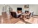 Inviting living room with a cozy fireplace, comfortable seating, and hardwood floors at 10792 Harbor Bay Dr, Fishers, IN 46040