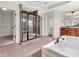 Luxurious main bathroom with soaking tub, glass shower, and access to walk-in closet at 10792 Harbor Bay Dr, Fishers, IN 46040