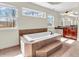 Bright main bathroom with tiled floors, vanity area, and a large soaking tub at 10792 Harbor Bay Dr, Fishers, IN 46040