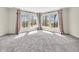 Bright main bedroom with large windows dressed with stylish curtains at 10792 Harbor Bay Dr, Fishers, IN 46040