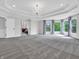 Spacious main bedroom featuring tray ceiling, bay windows, and a view into another room at 10792 Harbor Bay Dr, Fishers, IN 46040