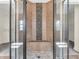 Beautifully tiled shower with river rock accent and frameless glass surround at 10792 Harbor Bay Dr, Fishers, IN 46040