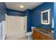 Bathroom with modern fixtures, including a tub and wood vanity at 110 E Washington St # 802, Indianapolis, IN 46204
