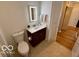 Small, bright bathroom featuring an updated vanity, tiled floors, and modern lighting at 110 E Washington St # 802, Indianapolis, IN 46204