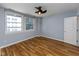 Bedroom with lots of natural light, light blue walls, and beautiful wood floors at 110 E Washington St # 802, Indianapolis, IN 46204