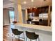 Kitchen featuring granite countertops, updated appliances, hardwood floors, and breakfast bar at 110 E Washington St # 802, Indianapolis, IN 46204