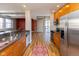 Modern kitchen with stainless steel appliances and adjacent living area with exposed brick wall at 110 E Washington St # 802, Indianapolis, IN 46204