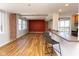 Open-concept living area with hardwood floors, brick accent wall, and a kitchen bar with seating at 110 E Washington St # 802, Indianapolis, IN 46204