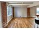 Bright living room featuring hardwood floors, exposed brick accents, and lots of natural light at 110 E Washington St # 802, Indianapolis, IN 46204