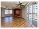 Bright living room boasts natural light, hardwood floors, a ceiling fan, and a balcony with city views at 110 E Washington St # 802, Indianapolis, IN 46204