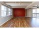 A large living room with lots of light, hardwood floors, and a red accent wall at 110 E Washington St # 802, Indianapolis, IN 46204