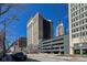 An eye-level street view showcasing the building's architecture and urban setting on a sunny day at 110 E Washington St # 802, Indianapolis, IN 46204