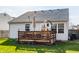 Wooden deck off the rear of the house with table, umbrella, and decorative features at 11930 Titania Cir, Indianapolis, IN 46236
