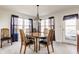 Dining room with wood table, six chairs, sheer curtains, and a decorative light fixture at 11930 Titania Cir, Indianapolis, IN 46236