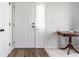 Bright entryway featuring a white front door, coat closet, and a wooden table with decorative accents at 11930 Titania Cir, Indianapolis, IN 46236