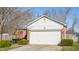 Charming single-Gathering home featuring brick accents, a white garage door, and well-maintained landscaping at 11930 Titania Cir, Indianapolis, IN 46236