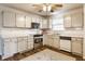 Traditional kitchen featuring white cabinetry, stainless steel appliances, and a patterned area rug at 11930 Titania Cir, Indianapolis, IN 46236