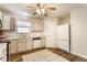 Bright kitchen with white cabinets, stainless steel appliances, and hardwood floors with an accent rug at 11930 Titania Cir, Indianapolis, IN 46236
