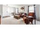 Inviting living room with a comfortable leather sofa, armchair, and natural light from the windows at 11930 Titania Cir, Indianapolis, IN 46236