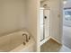 Relaxing bathroom features a soaking tub and a separate shower with a glass door at 12416 Teacup Way, Indianapolis, IN 46235
