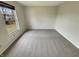 A bright bedroom with a view to the neighborhood and neutral-colored carpet at 12416 Teacup Way, Indianapolis, IN 46235