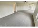 The large bonus room offers a ceiling fan, neutral carpet, and a lot of natural light at 12416 Teacup Way, Indianapolis, IN 46235