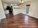 Open dining area with modern chandelier and wood-look flooring adjacent to the kitchen at 12416 Teacup Way, Indianapolis, IN 46235