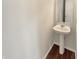 A simple powder room with a pedestal sink and white walls at 12416 Teacup Way, Indianapolis, IN 46235