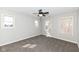 Neutral bedroom with three windows, ceiling fan, and carpeted floors at 13082 Overview Dr # 5A, Fishers, IN 46037