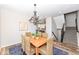 Charming dining room with stylish chandelier, wood table with seating for four, and hardwood flooring at 13082 Overview Dr # 5A, Fishers, IN 46037